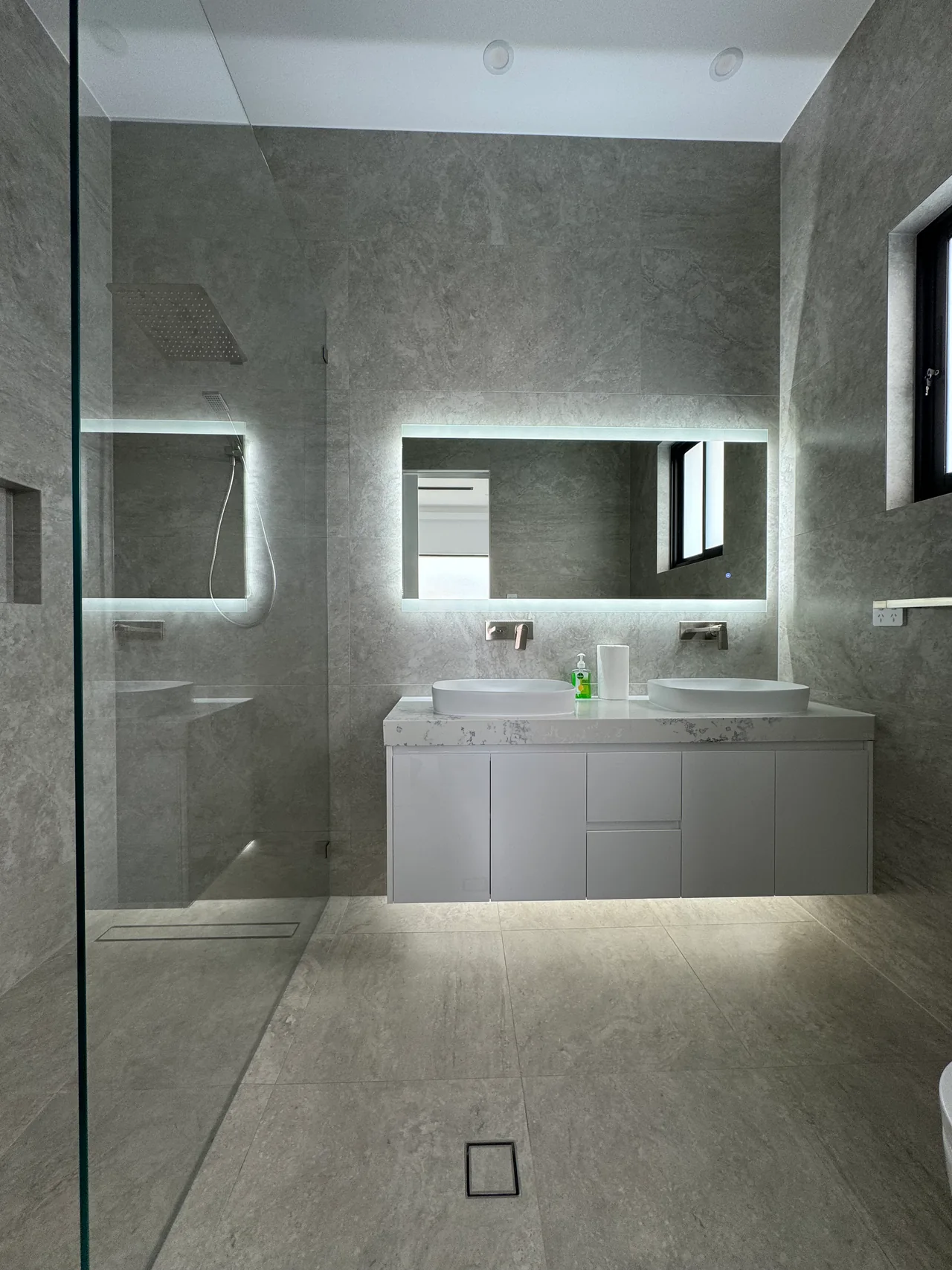 Front view of the Edensor Park double vanity and illuminated mirror beside the walk-in shower